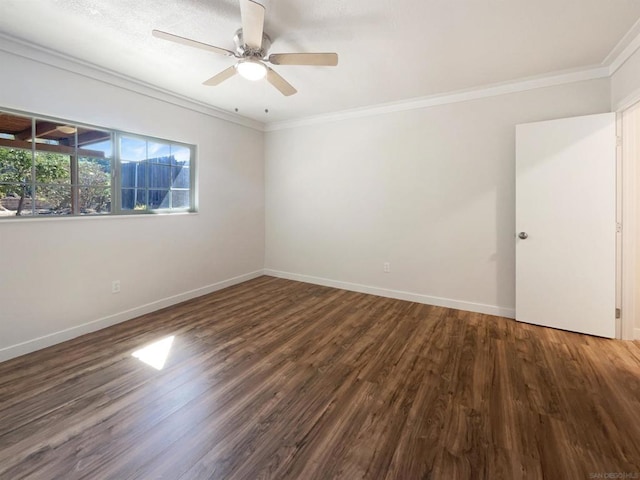 empty room featuring ceiling fan, ornamental molding, and dark wood-type flooring