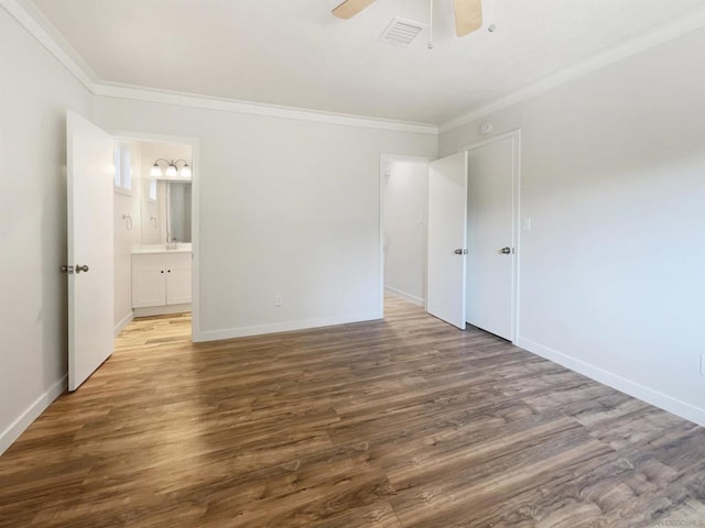 unfurnished bedroom featuring dark hardwood / wood-style flooring, ensuite bathroom, ceiling fan, and crown molding