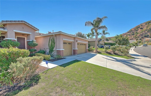 view of front of property featuring a mountain view, a garage, and a front lawn