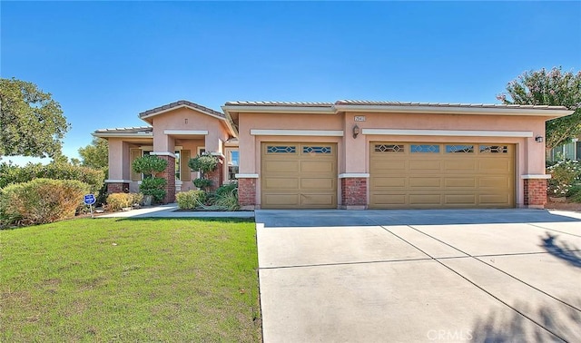 view of front of house featuring a garage and a front lawn