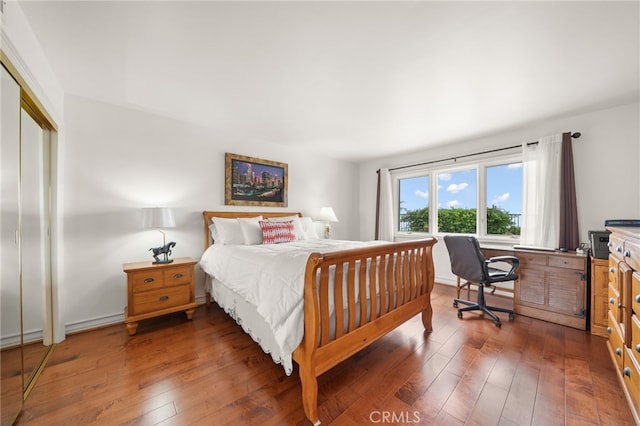 bedroom with dark wood-type flooring