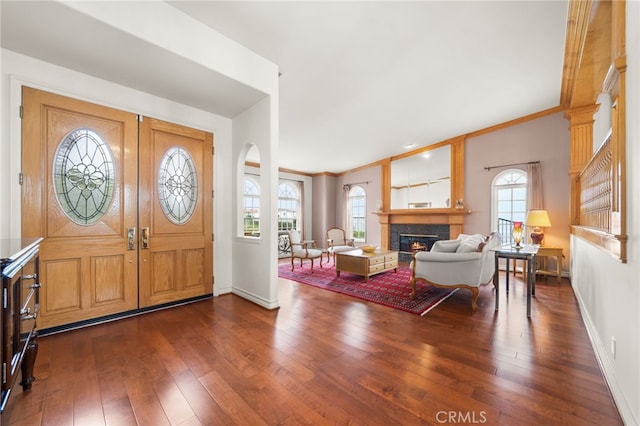 entryway featuring ornamental molding, dark wood-type flooring, and french doors