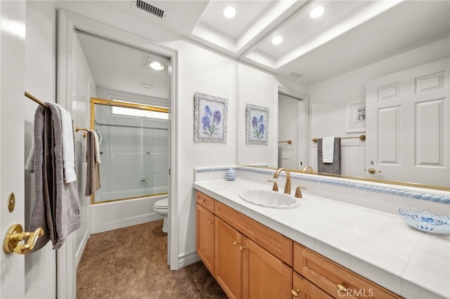 bathroom with toilet, shower / bath combination with glass door, visible vents, vanity, and recessed lighting