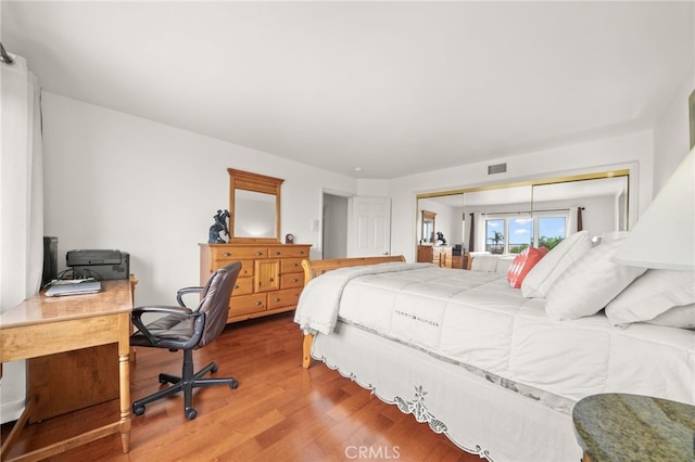 bedroom featuring hardwood / wood-style flooring and a closet