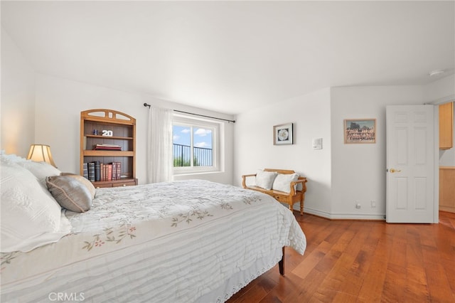 bedroom with wood finished floors and baseboards