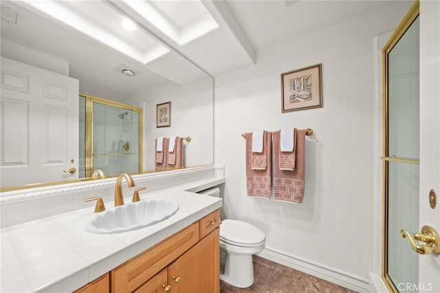 bathroom featuring toilet, a shower with door, and vanity