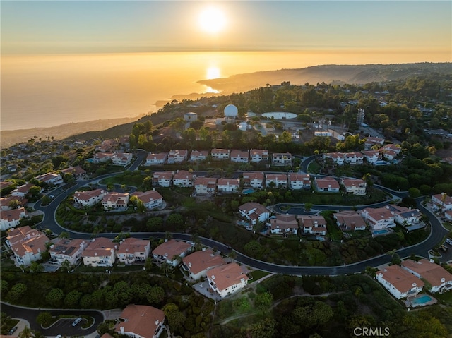 aerial view at dusk with a water view