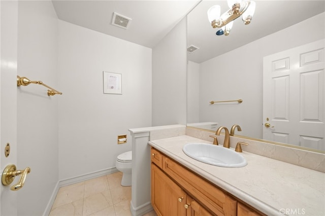 bathroom featuring toilet, baseboards, vanity, and visible vents