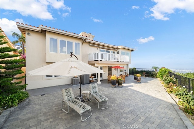 back of property with a patio and central air condition unit