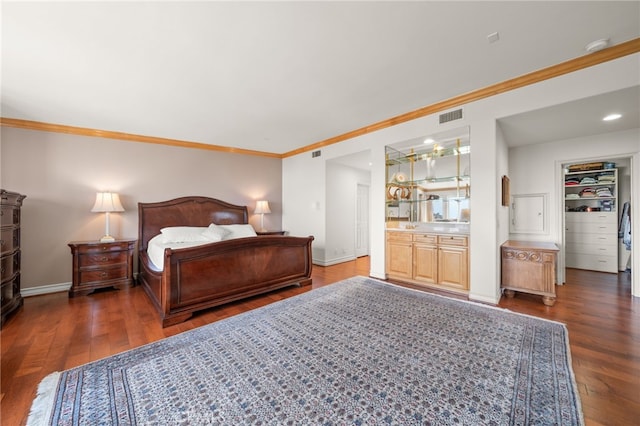 bedroom featuring baseboards, crown molding, visible vents, and wood finished floors