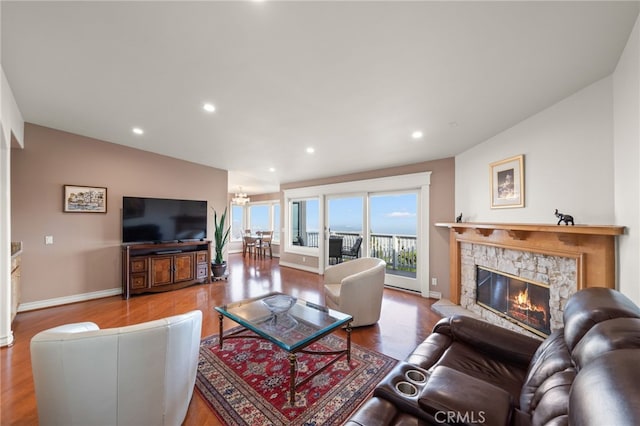 living room with a fireplace, recessed lighting, and wood finished floors
