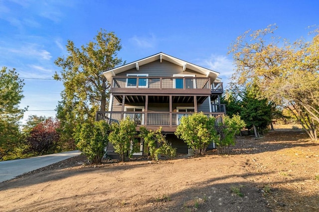 rear view of house with a wooden deck