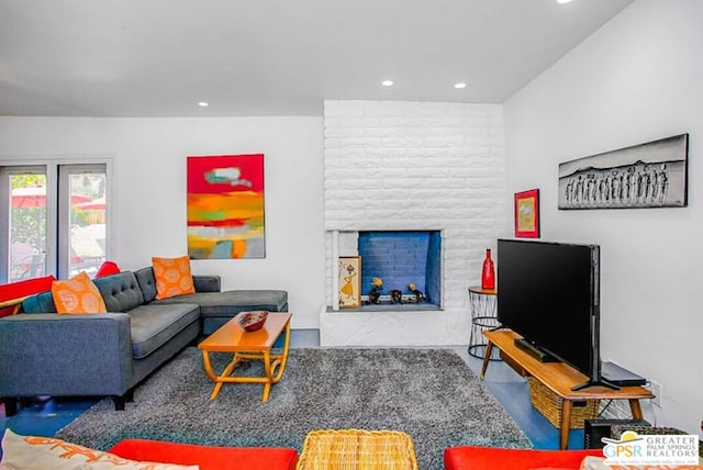 living room featuring hardwood / wood-style floors and a brick fireplace