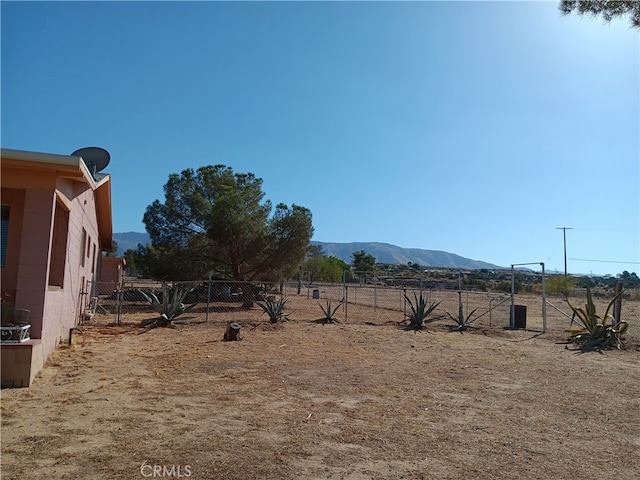 view of yard featuring a rural view and a mountain view