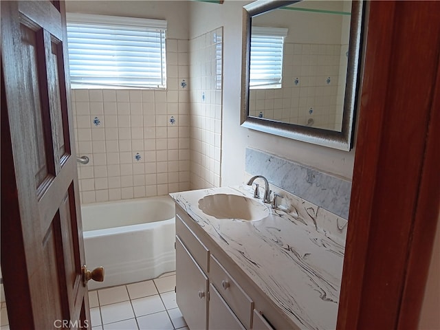 bathroom with tile patterned floors, vanity, and a wealth of natural light