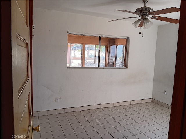 tiled empty room with ceiling fan