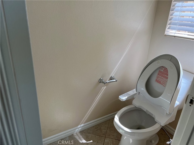 bathroom with tile patterned flooring and toilet