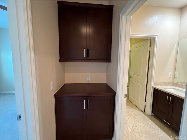 interior space featuring light tile patterned floors and dark brown cabinetry