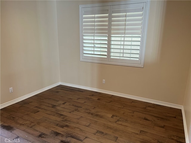 empty room featuring dark hardwood / wood-style flooring