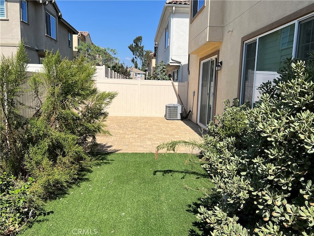 view of yard featuring central AC unit and a patio area