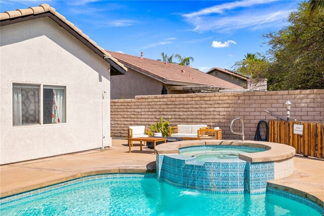 view of pool featuring a patio area and an in ground hot tub