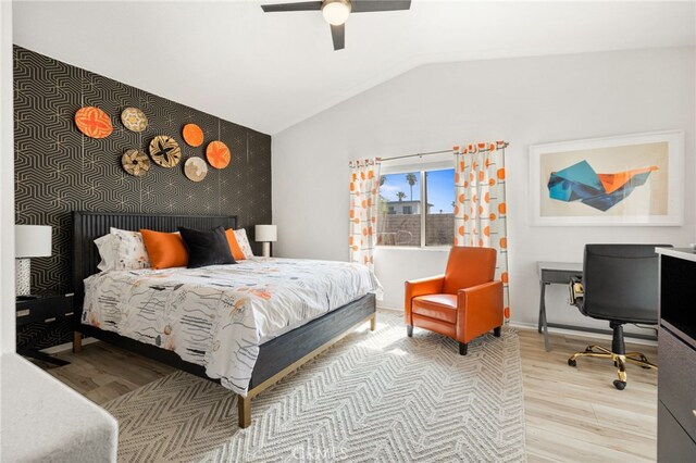 bedroom with light wood-type flooring, vaulted ceiling, and ceiling fan