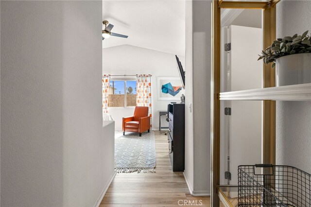 hall with light hardwood / wood-style floors and vaulted ceiling