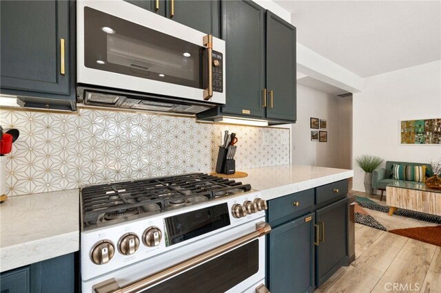 kitchen with decorative backsplash, white gas stove, and light wood-type flooring