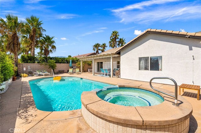 view of swimming pool with a patio area and an in ground hot tub