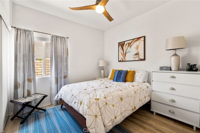 bedroom with ceiling fan and dark wood-type flooring