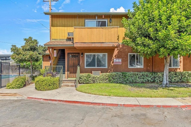 view of front of property with a balcony