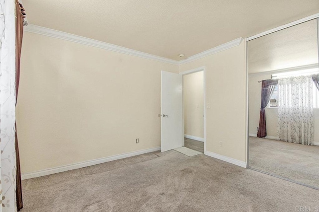 unfurnished bedroom with ornamental molding, a closet, and light colored carpet