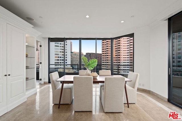 dining room featuring ornamental molding and expansive windows