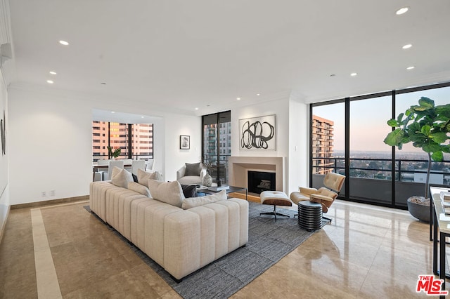 living room featuring floor to ceiling windows and crown molding