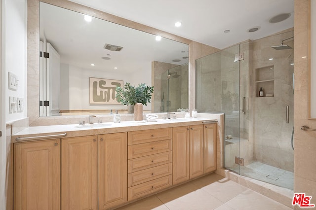 bathroom with vanity, tile patterned flooring, and a shower with shower door