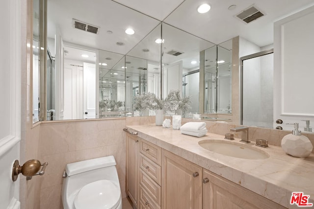 bathroom featuring toilet, walk in shower, and vanity