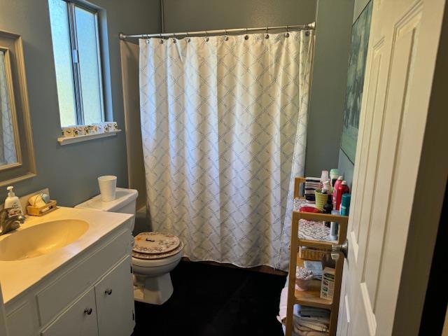 full bathroom with vanity, shower / bathtub combination with curtain, and toilet