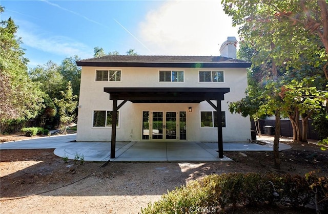 rear view of house featuring french doors