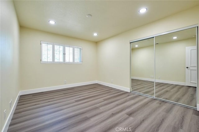 unfurnished bedroom with light hardwood / wood-style floors and a closet