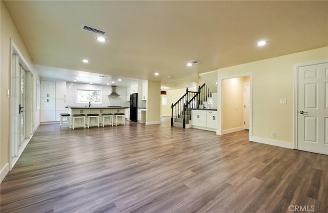 unfurnished living room with dark hardwood / wood-style floors and sink