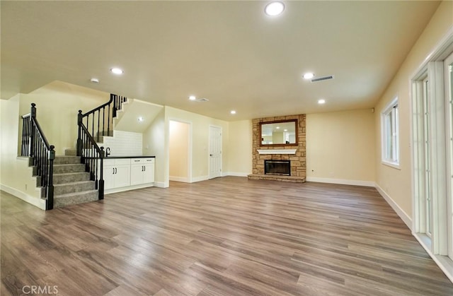 unfurnished living room with a fireplace and hardwood / wood-style flooring