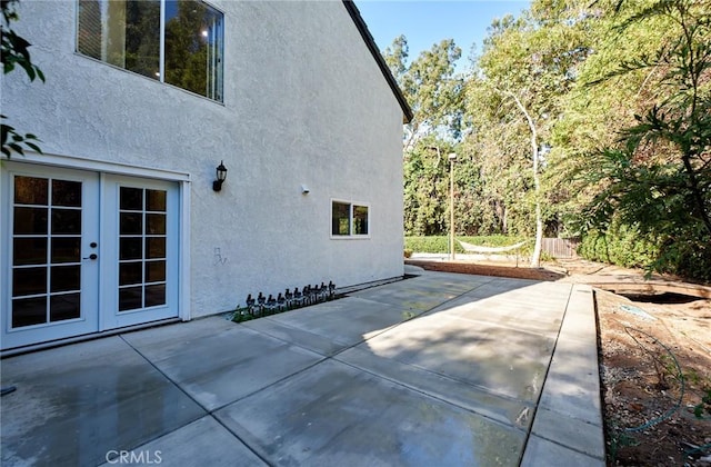 view of side of home with a patio area and french doors