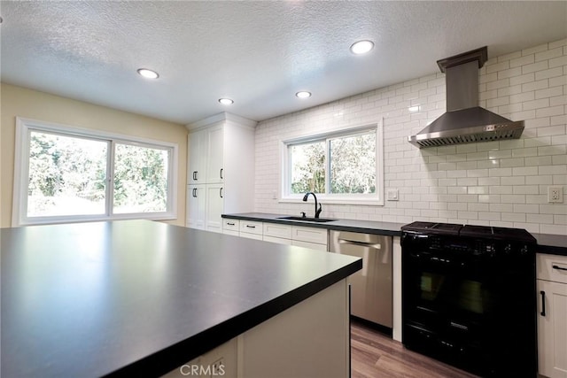 kitchen with white cabinets, plenty of natural light, black electric range oven, and sink