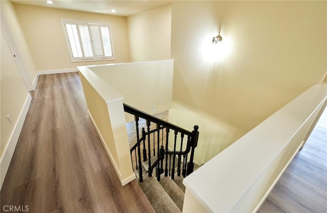 stairs featuring wood-type flooring