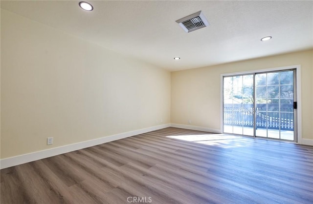 empty room with wood-type flooring