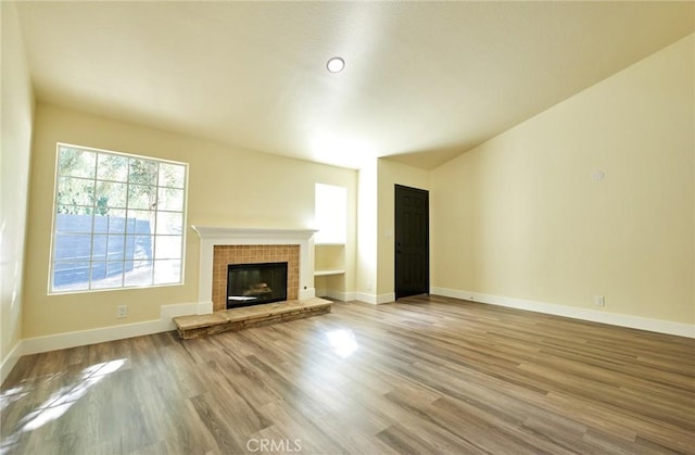 unfurnished living room with a fireplace and hardwood / wood-style flooring