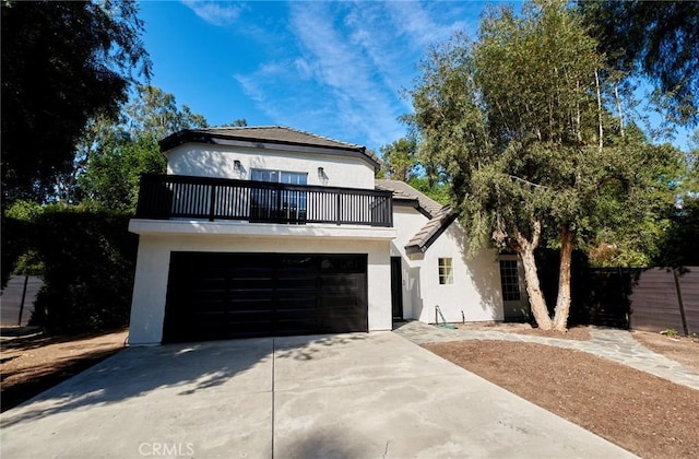 view of front of property featuring a balcony and a garage