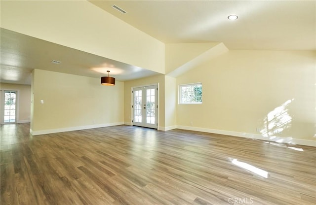 unfurnished room with french doors, vaulted ceiling, and hardwood / wood-style floors