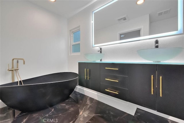 bathroom featuring a tub to relax in and vanity