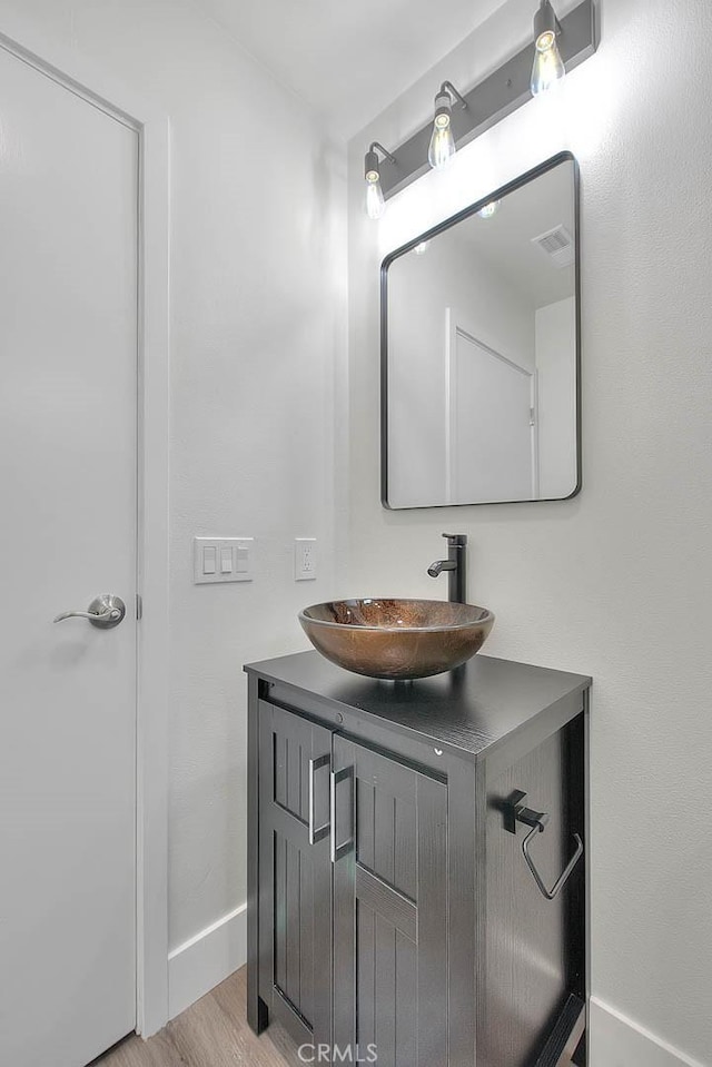 bathroom featuring hardwood / wood-style flooring and vanity